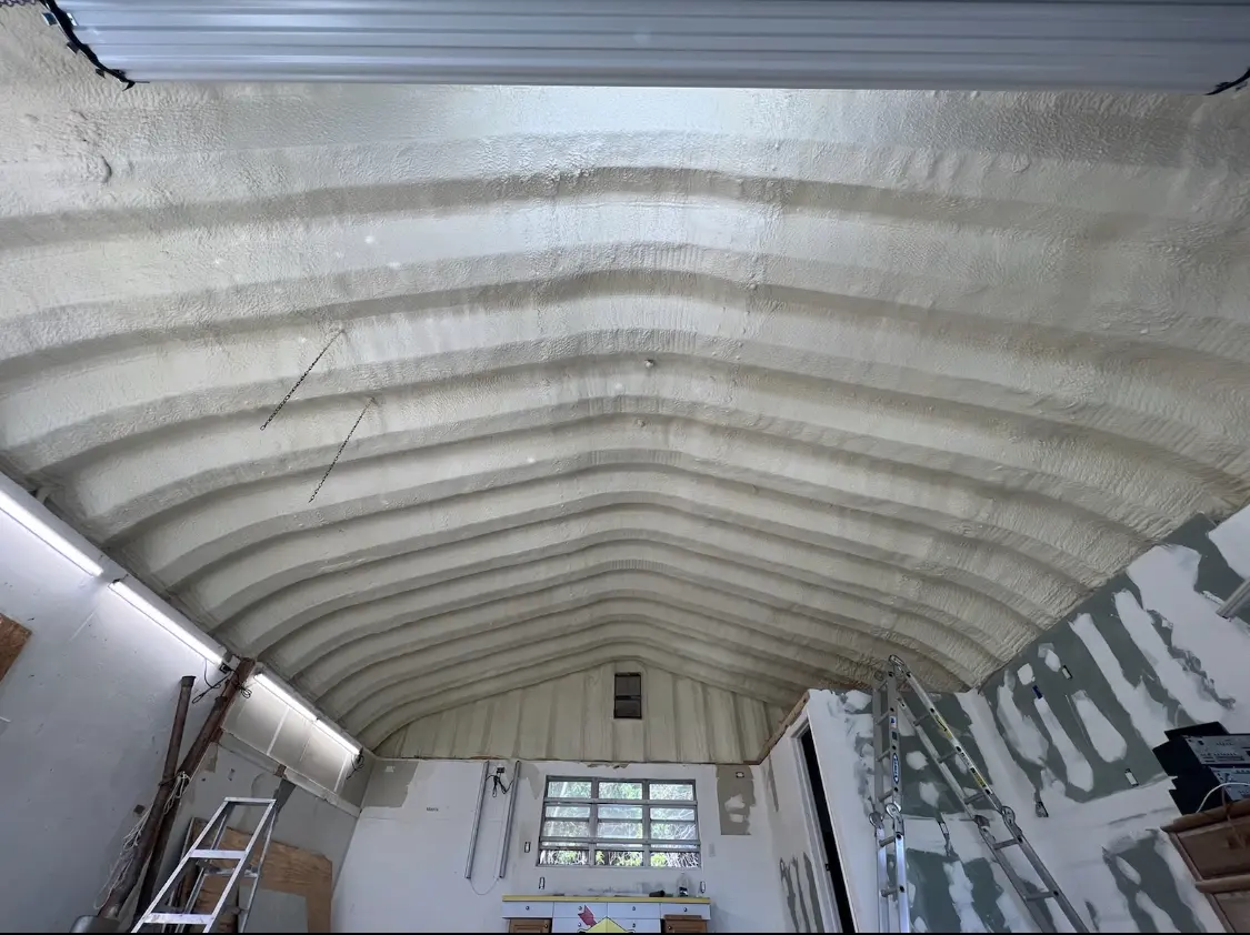 Spray polyurethane foam applied to the underside of a metal roof deck in Fenton